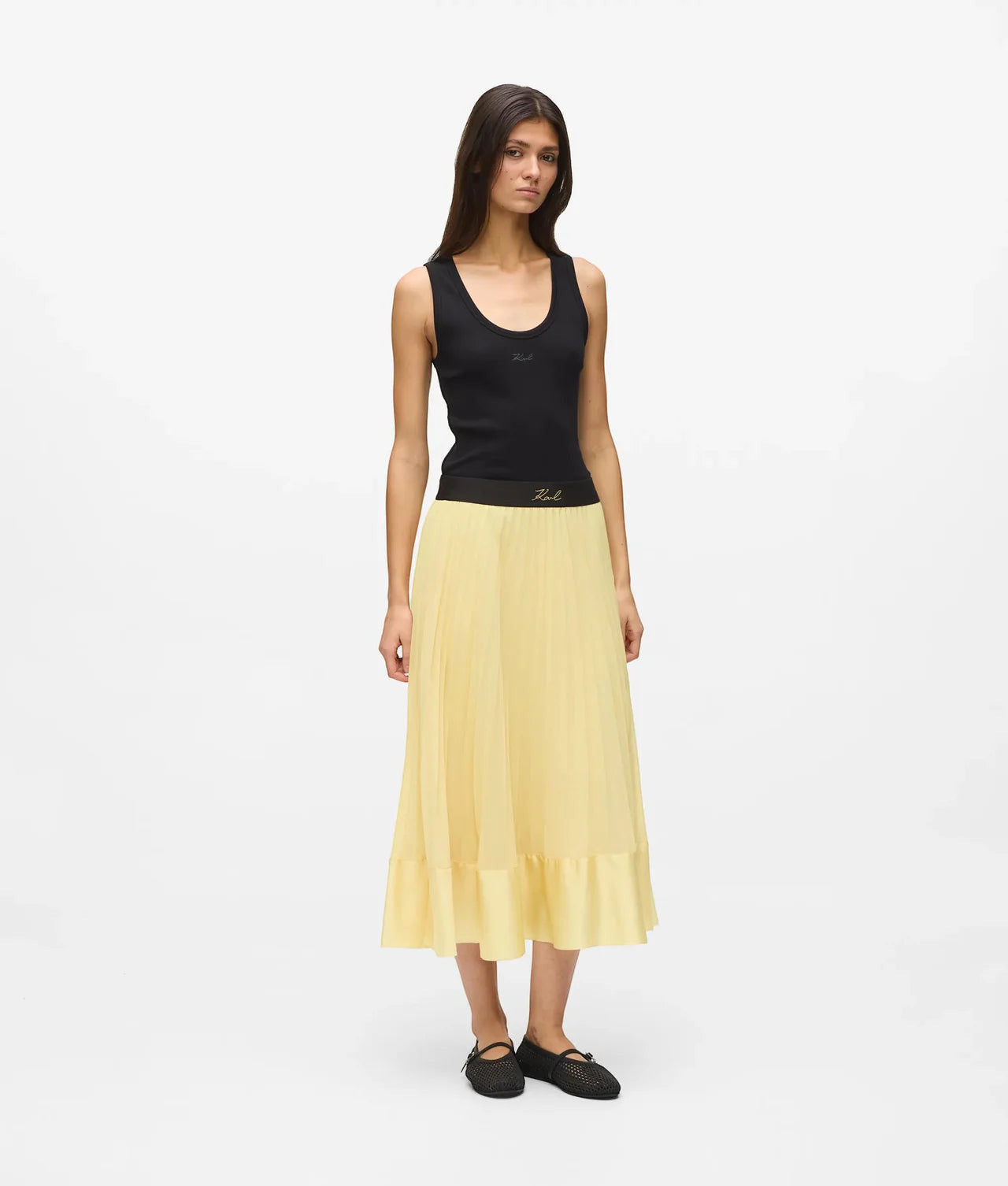 MiLA Boutique yellow satin pleated midi skirt with elasticated waistband and ruffled hem, worn by a model.