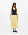 MiLA Boutique yellow satin pleated midi skirt with elasticated waistband and ruffled hem, worn by a model.